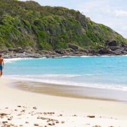 Person walking along Boomerang Beach NSW.