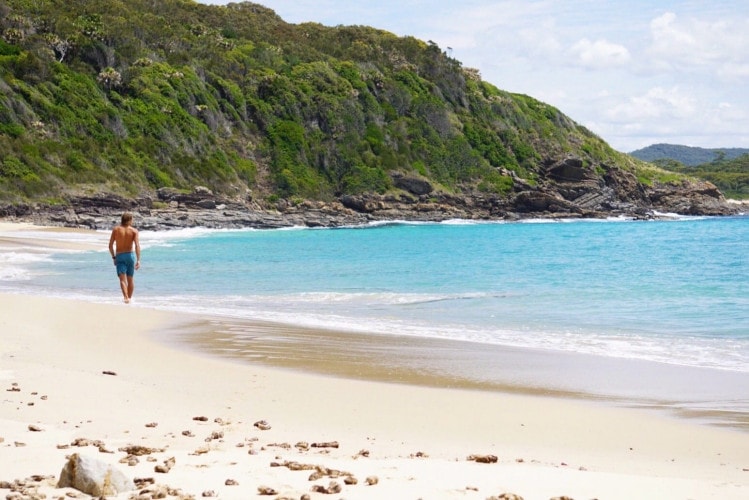 Person walking along Boomerang Beach NSW.