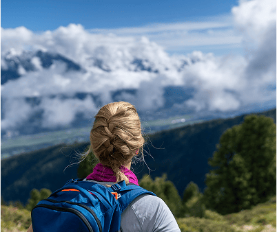 Woman hiking looking at the hills