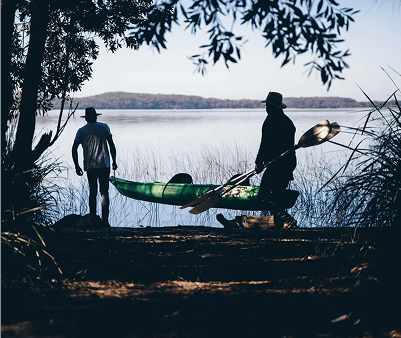 2 people carrying a Kayak